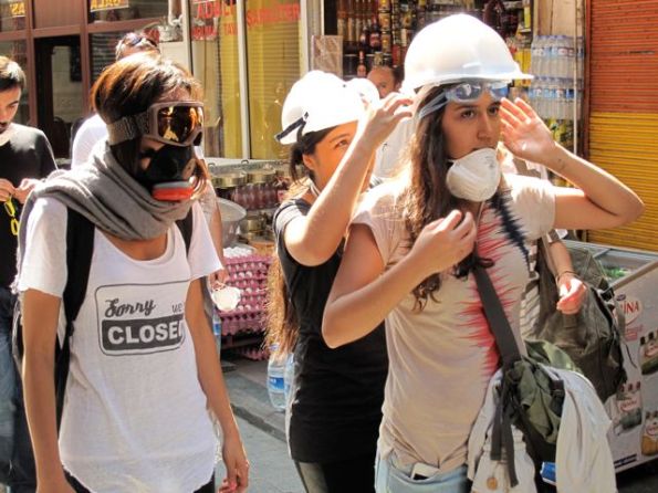Middle-class girls fix their gear as they try to find a way past police lines to recover Taksim.
